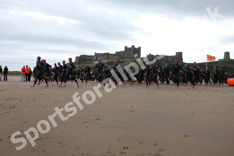 Start of the swimming during the Bamburgh Triathlon with Bamburgh Castle in the background